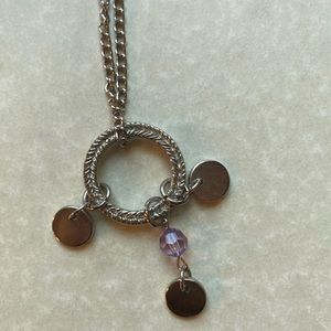 Silver necklace with purple beads.